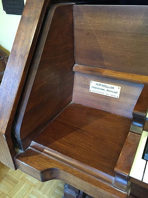Oil-based red mahogany stain on organ fading to dark brown color