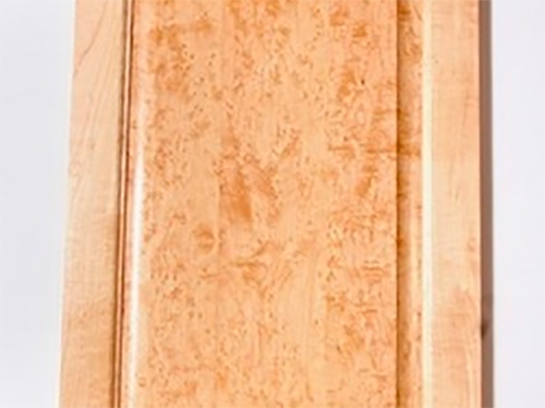 A non-uniform stain applied across a maple cabinet panel