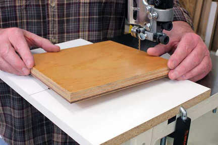 Setting workpiece on dowel in band saw cutting jig