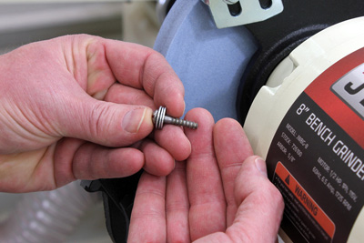 View of a screw that has been flattened by grinding wheel