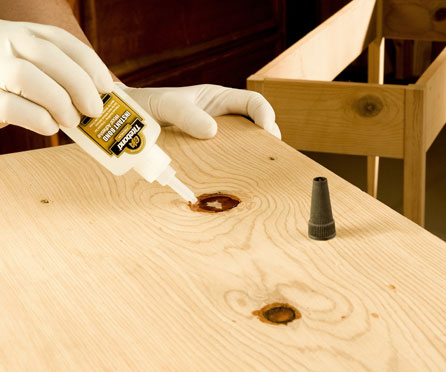 Using cyanoacrylate glue to repair a knot in a wood panel