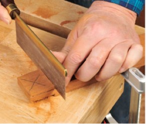 Using a saw to hand cut tenons