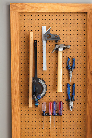 Hanging miter gauge on a workshop pegboard