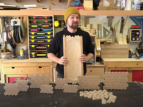 Michael Alm with various panels made out of patterened plywoods