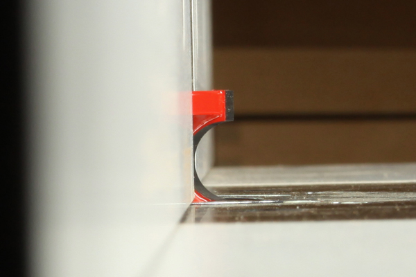 Side view of half round router bit installed in a router table