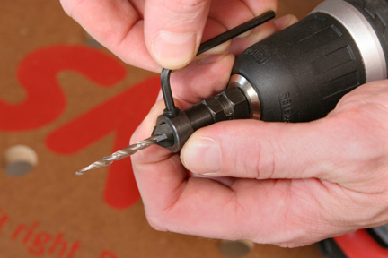 Using a hex wrench to install countersink bit in drill