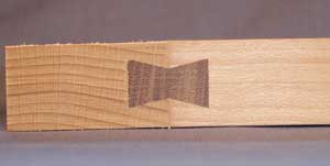 Close-up of dovetail inlay fitted into breadboard end