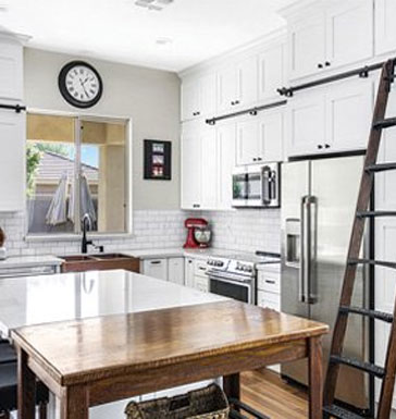 Three tiered kitchen cabinets with access ladder