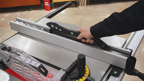 Push stick and rip fence on an F2 table saw