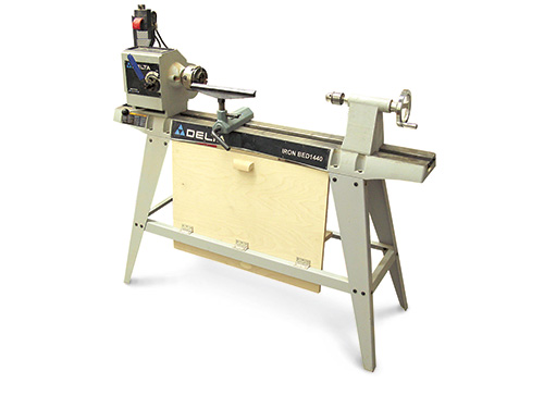 Tool storage panel stored closed against lathe base