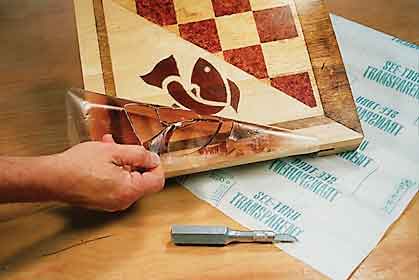 Using a transparent sheet to create patterned stain