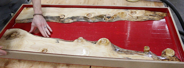 Laying out two sides of pine table in epoxy pouring mold