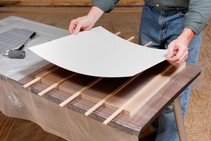 Applying laminate across scrap wood spacers