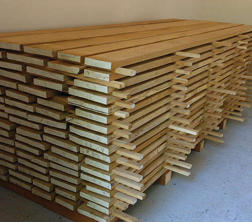 Lumber on a pallet in a kiln stacked for drying