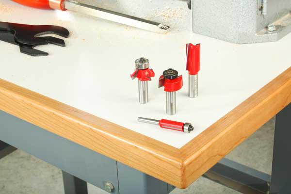 Workshop table with laminate top and four router bits