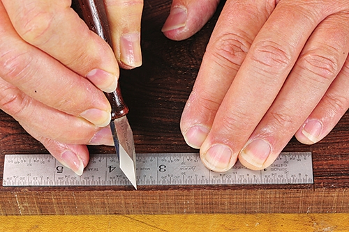 Marking cut line with marking knife and rule