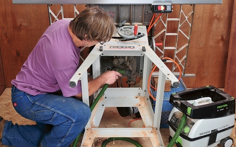 man fixing table saw