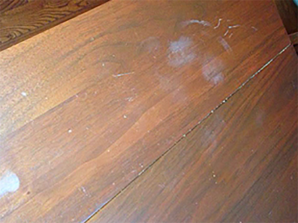 Antique walnut table with white markings on finish