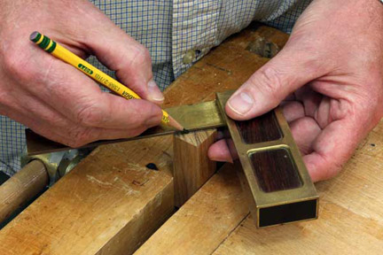 Drawing a center point for drilling a blank in pencil