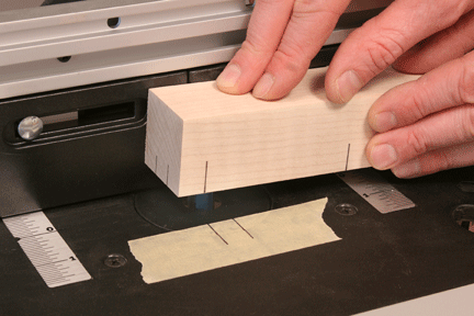 Matching the reference line on a piece of wood to the piece of tape