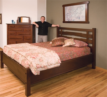 Mike McGlynn showing off his mission-style bedroom set