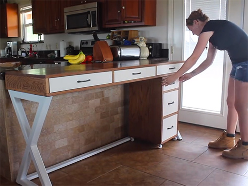 April Wilkerson finishes placing filing cabinet on metal framed desk