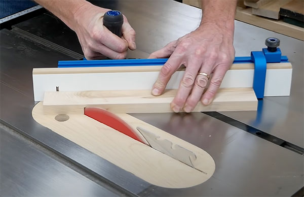 stop block positioned on miter gauge fence