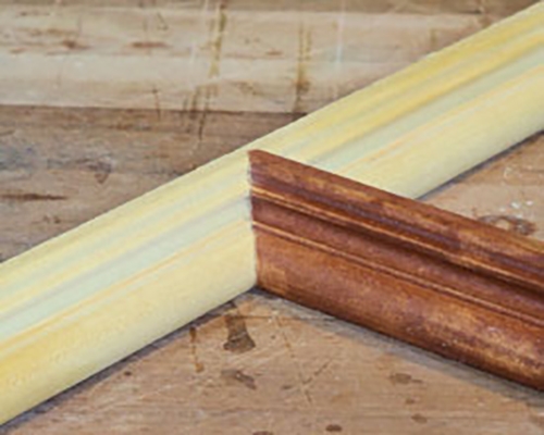 Molding intersection with joint cut by a coping saw