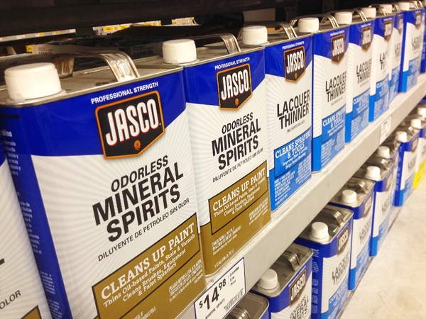 Store shelf stocked with mineral spirits and paint thinners