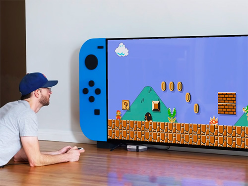 Chris Salomone using video game console cabinet