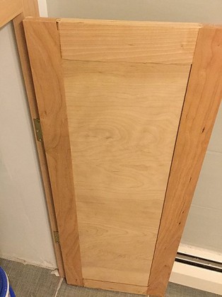 Interior view of cabinet door with inset hinges