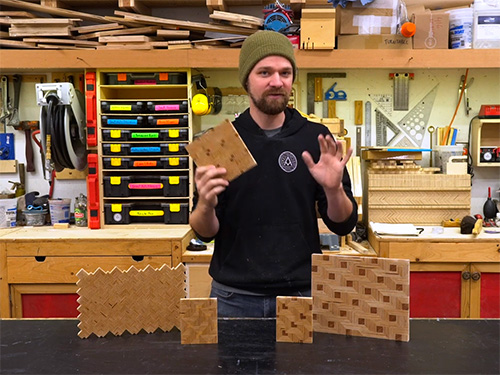 Michael Alm showing several patterned plywood panels