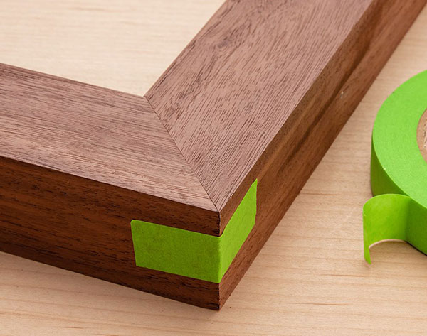 picture frame miter joint clamped with tape