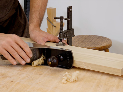 Smoothing wood surface with hand plane