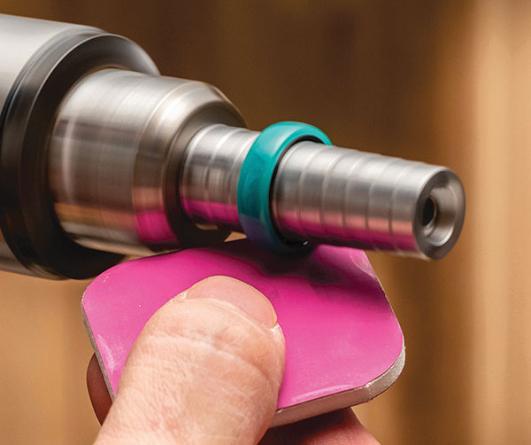 sanding and polishing an acrylic ring on a lathe