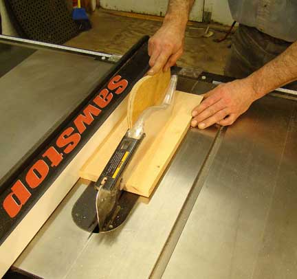 Ripping board against table saw fence