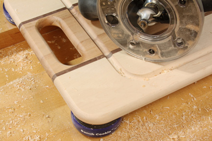 Close-up of a roundover bit that has routed cutting board channel