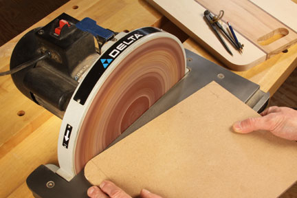 Smoothing cutting board corners with a disc sander