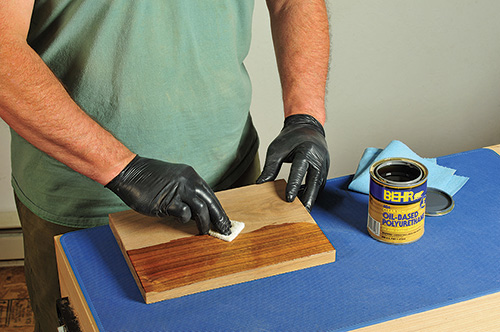 Scrubbing a polyurethane finish with a white Scotchbrite pad