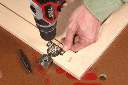 Using a self-centering bit to attach european hinge to cabinet door frame