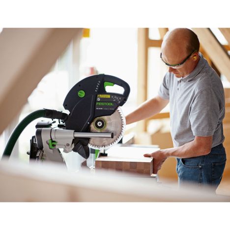 Adjusting wood set up across miter saw station