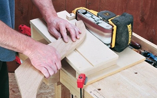 person using belt sander