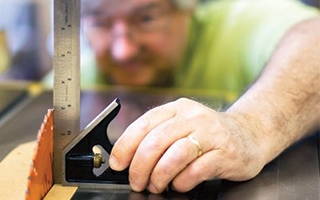Bill Hylton checking saw with combination square