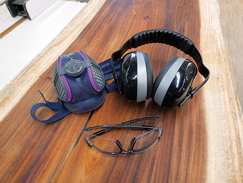 Safety equipment for band saw including a respirator, over-ear hearing protection and eye glasses