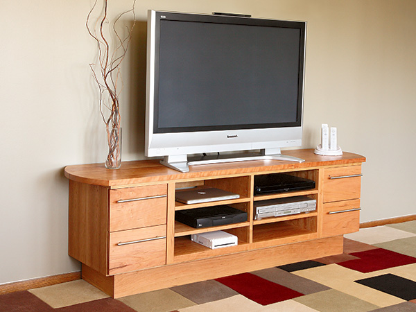 Media center with a slide out shelf for wiring