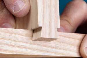 Demonstrating a sliding dovetail joint fitting into groove