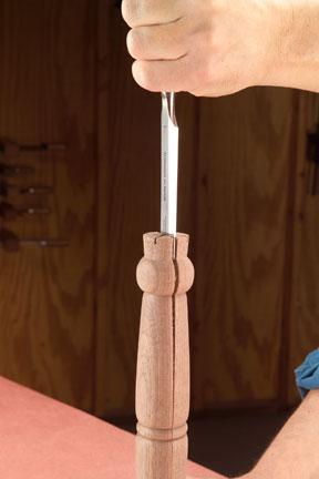 Using a chisel to disassemble a paper joint within a turning