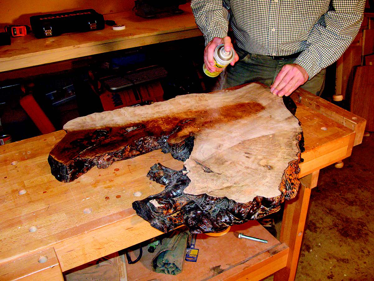 Spraying shellac on myrtle wood slab