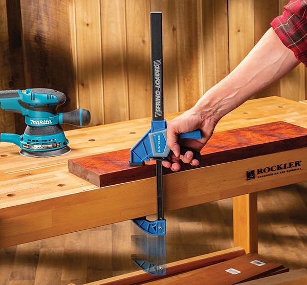 closing a Rockler spring-loaded clamp to secure a piece of wood