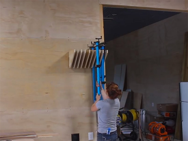 April Wilkerson organizes her bar clamps on the shop wall